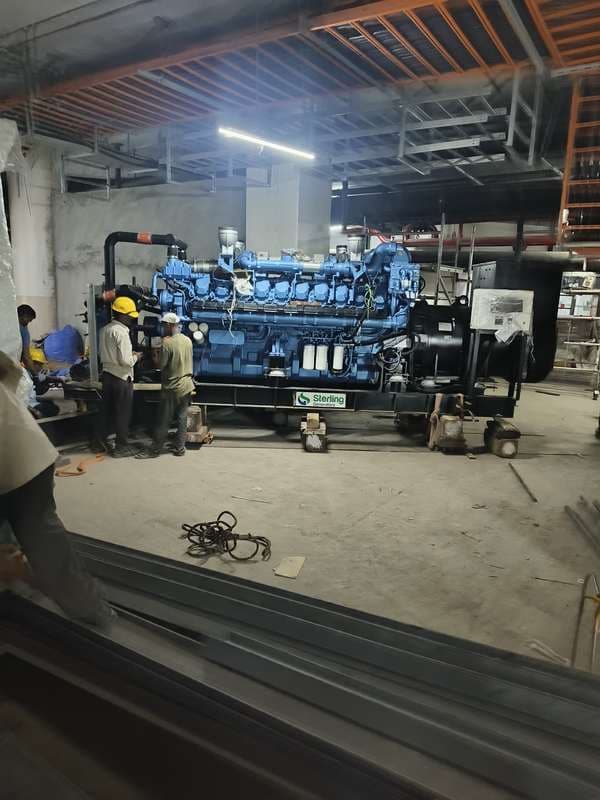 Large diesel generating set positioned inside a basement plant room.